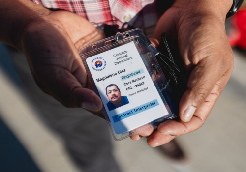 Photo of Brown hands showing an ID badge