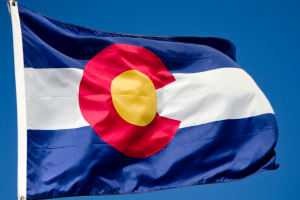 Photo of the Colorado State Flag against a blue sky